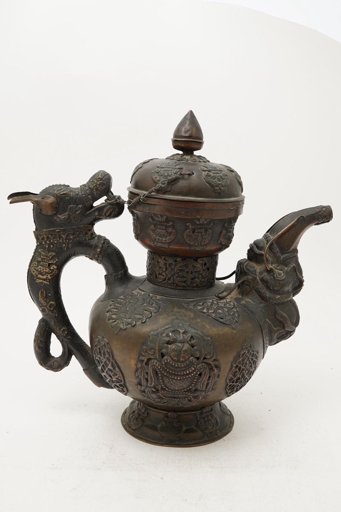 A large Tibetan repoussé brass and copper ewer, 19th century